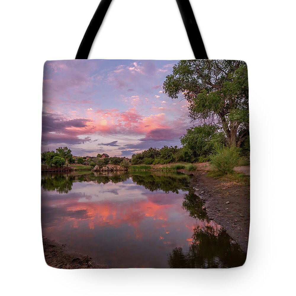 Sunset Tote Bag featuring the photograph Touching the Shore by Aaron Burrows