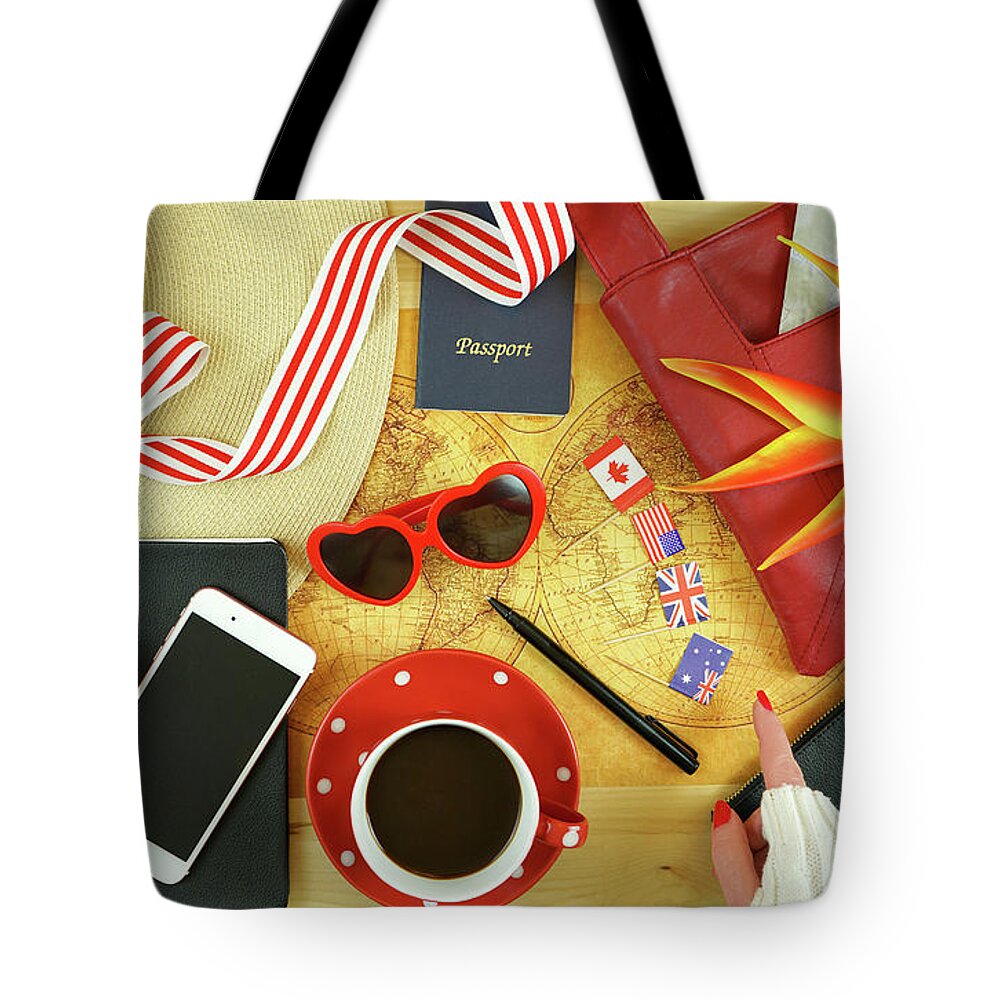 Travel Tote Bag featuring the photograph Travel concept planning with accessories and old pre-1900 map of the world. by Milleflore Images