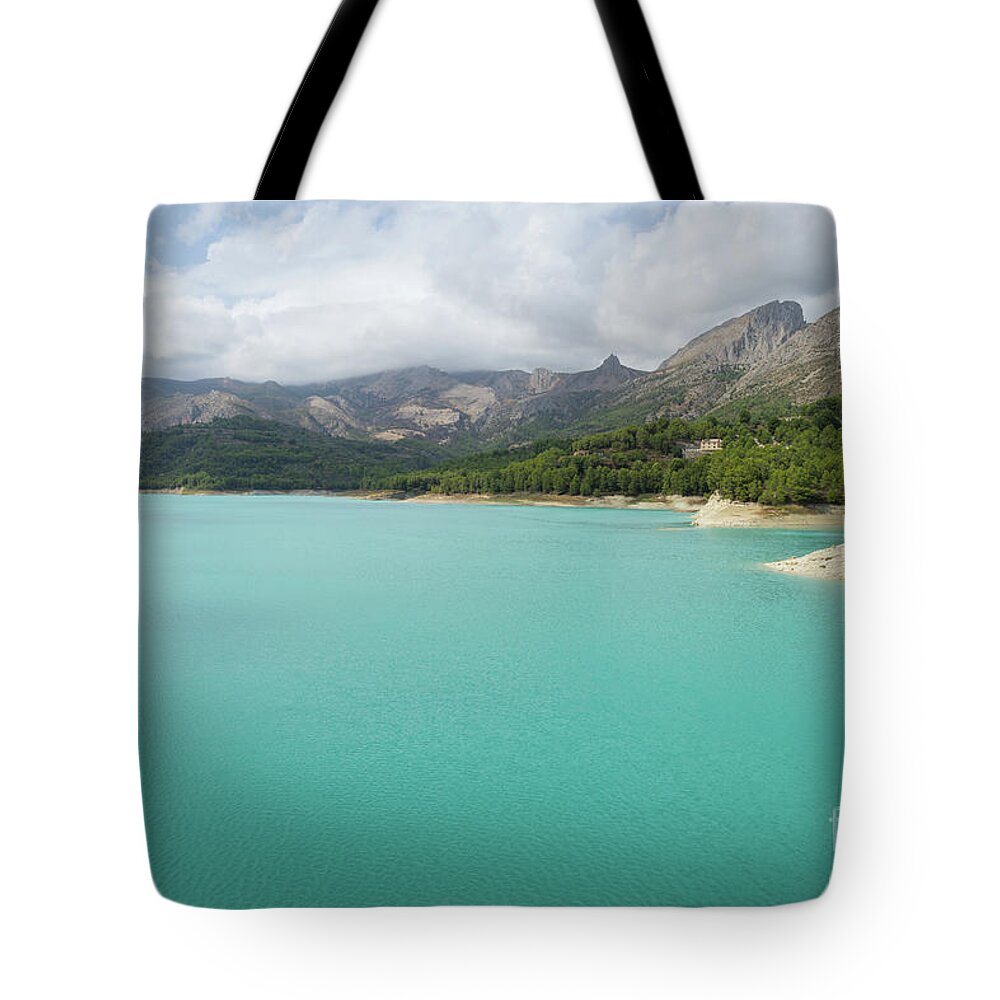 Guadalest Tote Bag featuring the photograph Turquoise blue water and mountain landscape by Adriana Mueller
