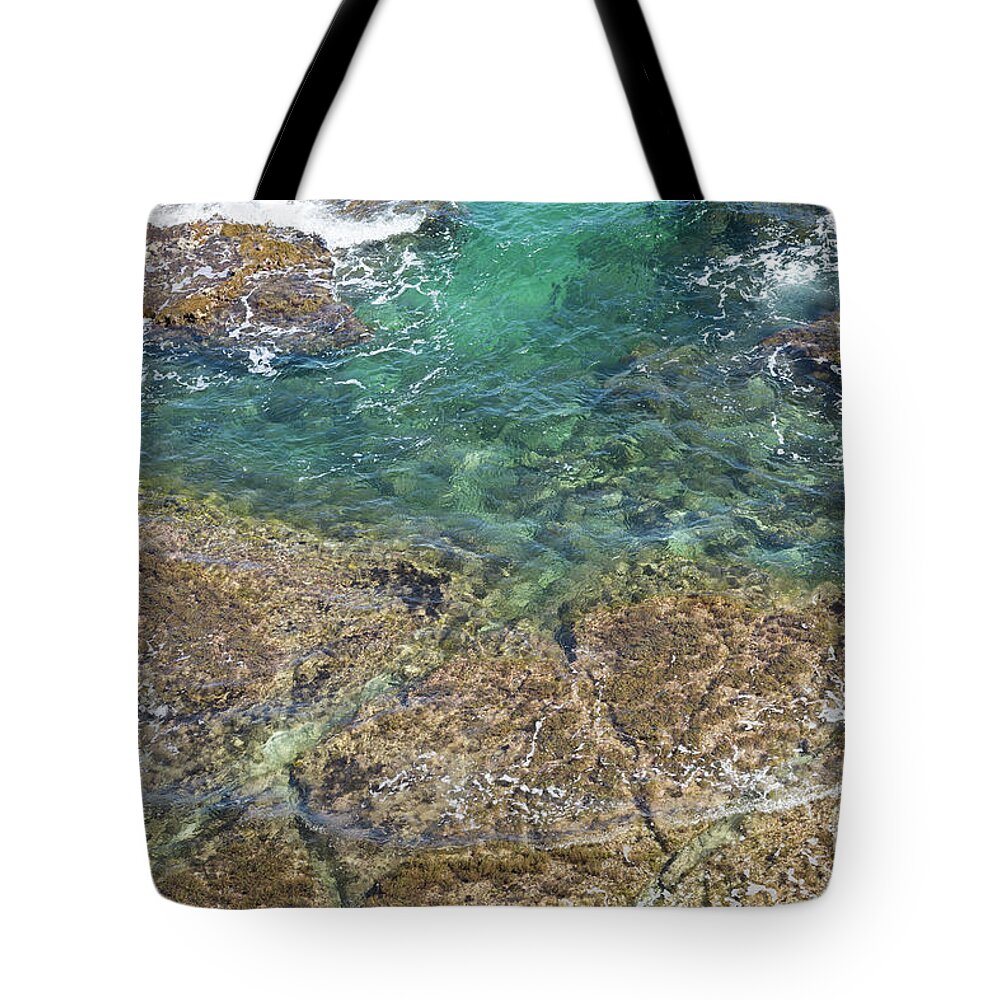 Turquoise Tote Bag featuring the photograph Turquoise Blue Water And Rocks On The Coast by Adriana Mueller