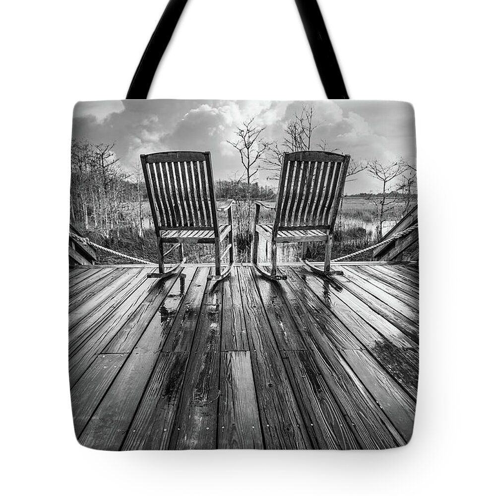 Clouds Tote Bag featuring the photograph Two Chairs after the Rain in Black and White by Debra and Dave Vanderlaan