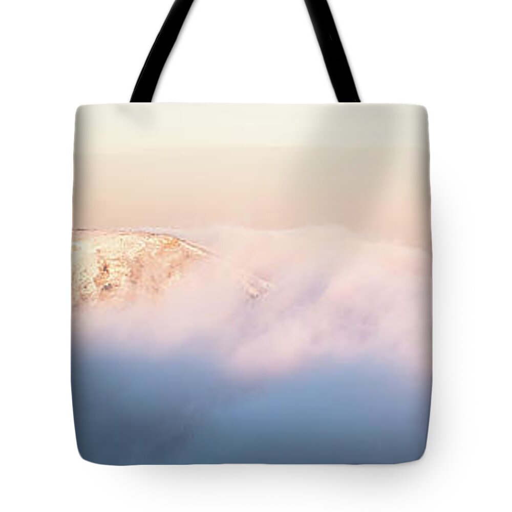 Abstract Tote Bag featuring the photograph Two peaks emerge from purple clouds at sunset by Jean-Luc Farges