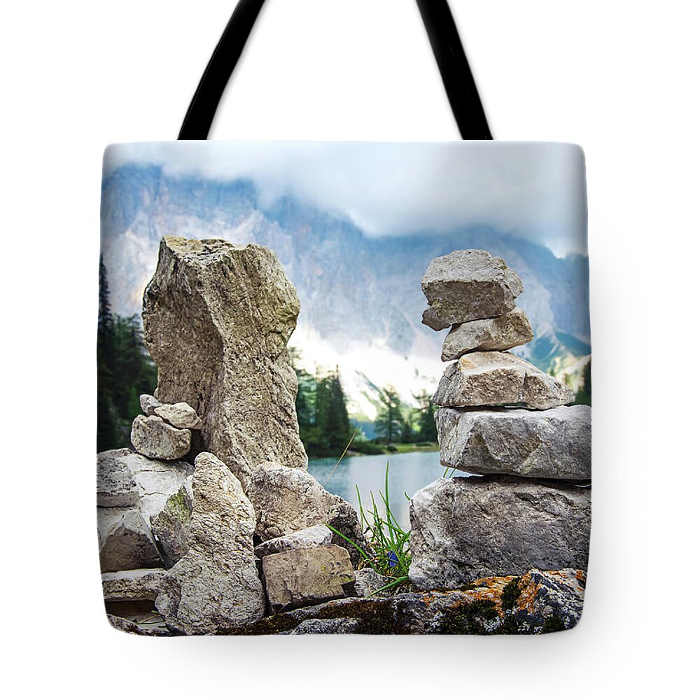 Two Tote Bag featuring the photograph Two stone towers as route markers. by Bernhard Schaffer