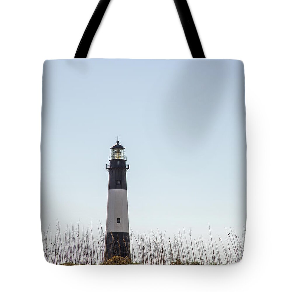 America Tote Bag featuring the photograph Tybee Island Lighthouse on dunes by Karen Foley