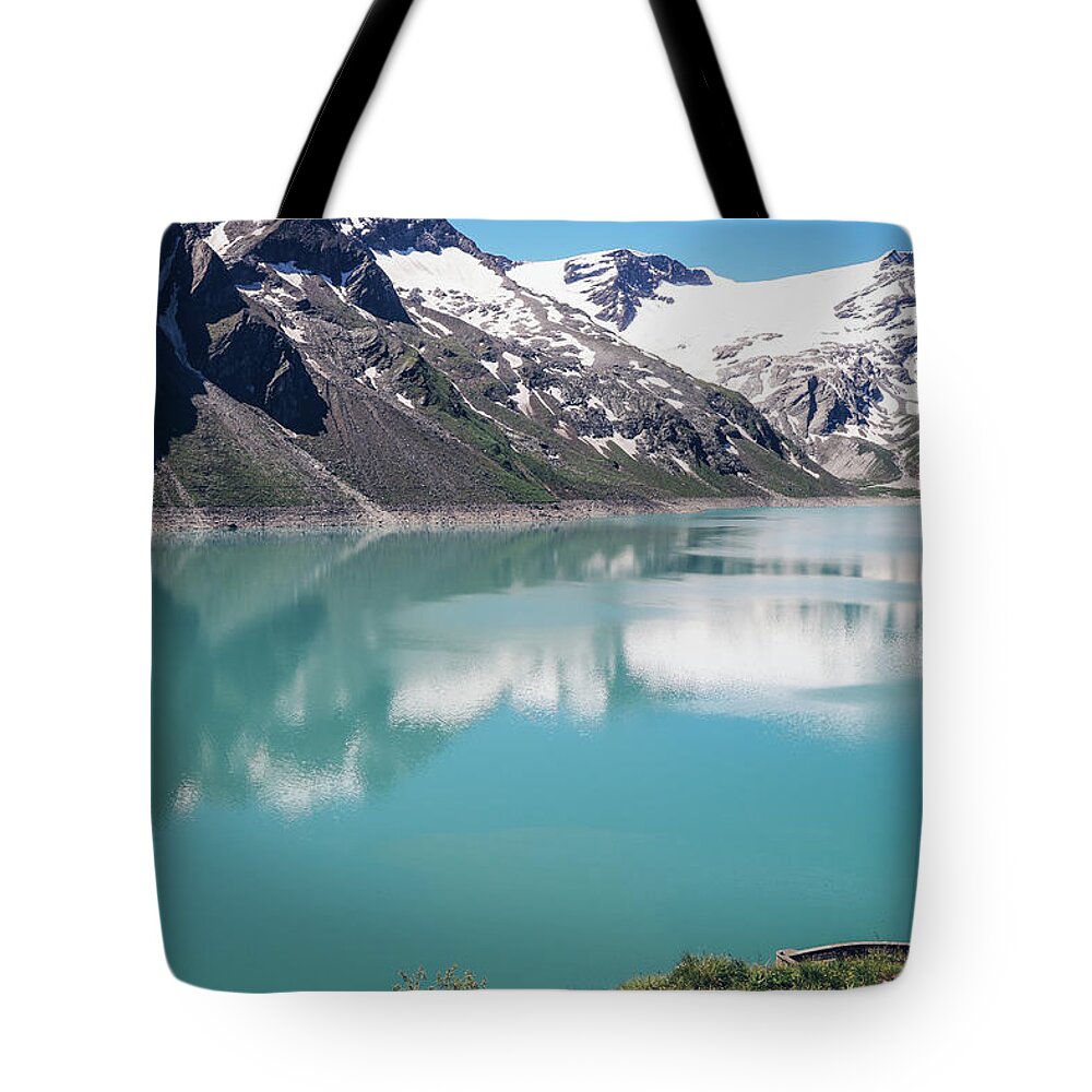 Adventure Tote Bag featuring the photograph View of the Stausee Mooserboden glacier dam by Vaclav Sonnek