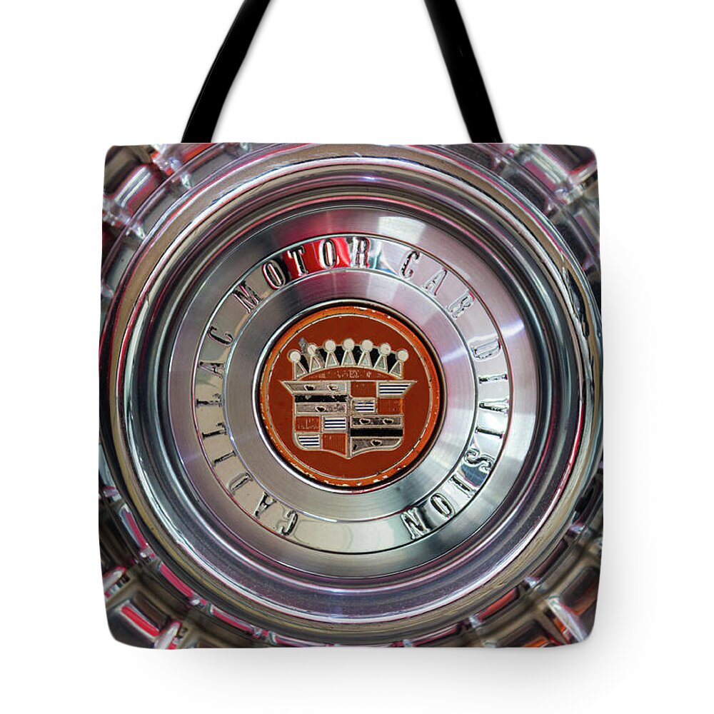 Cadillac Tote Bag featuring the photograph Vintage Cadillac De Ville Convertible 1967 wheel with emblem by Viktor Wallon-Hars