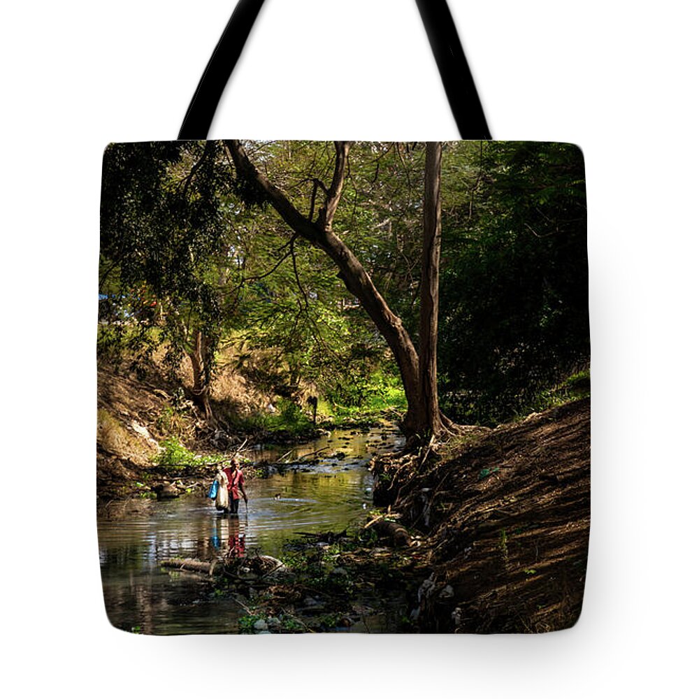 Wading Tote Bag featuring the photograph Wading the Jatibonico river by Micah Offman