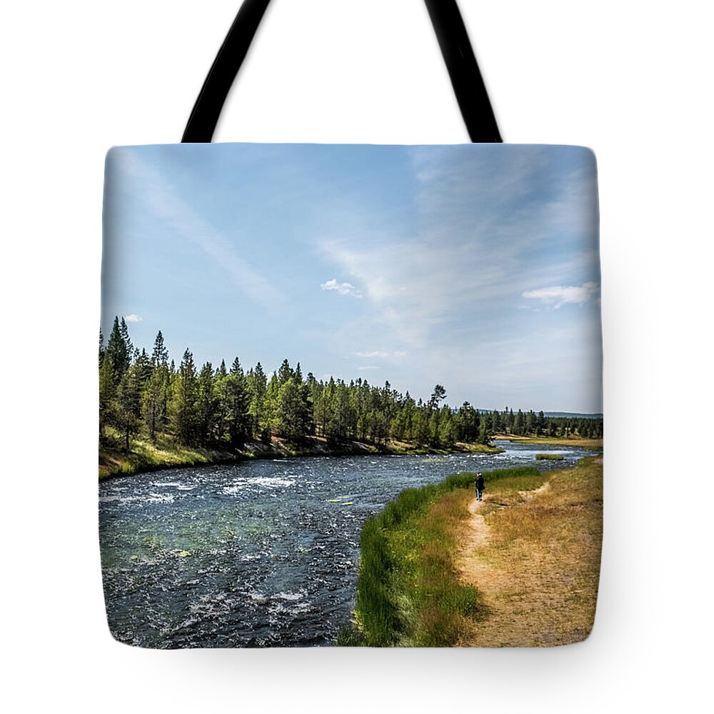 Yellowstone Tote Bag featuring the photograph Walking along the river by Alberto Zanoni