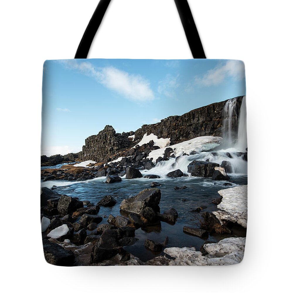 Oxararfoss Tote Bag featuring the photograph Waterfall flowing into the river, Iceland by Michalakis Ppalis