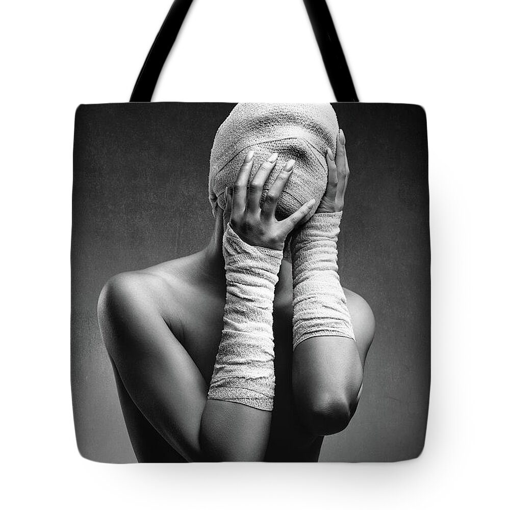 Woman Tote Bag featuring the photograph Woman in bandages by Johan Swanepoel