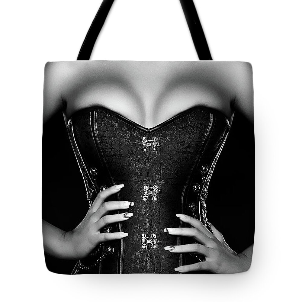 Woman Tote Bag featuring the photograph Woman wearing black corset by Johan Swanepoel