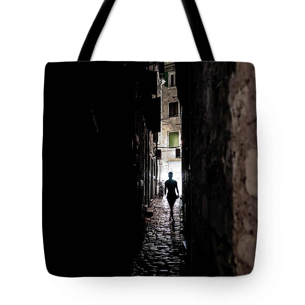  Tote Bag featuring the photograph Young Woman Walks Alone Through Spooky Narrow Abandoned Alley In The Night by Andreas Berthold