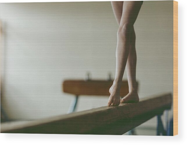 Child Wood Print featuring the photograph Female gymnast walking on balance beam, low section #1 by Vgajic