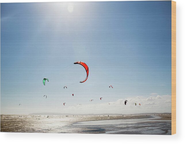 Water's Edge Wood Print featuring the photograph Kite Surfers #1 by Nick David