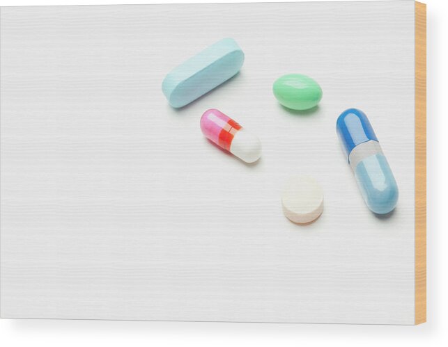 White Background Wood Print featuring the photograph Pills And Capsules On White Background #1 by Vstock Llc