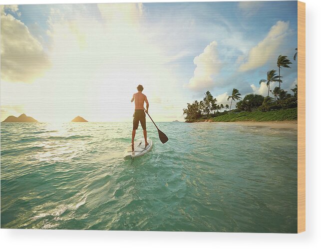Tranquility Wood Print featuring the photograph Caucasian Man On Paddle Board In Ocean #2 by Colin Anderson Productions Pty Ltd
