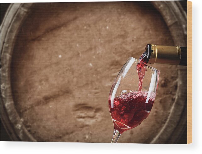 Alcohol Wood Print featuring the photograph Red Wine Poured Into Glas #4 by Valentinrussanov