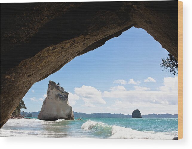 Tide Wood Print featuring the photograph A Natural Rock Arch And Rock Formations by Paul Quayle / Design Pics