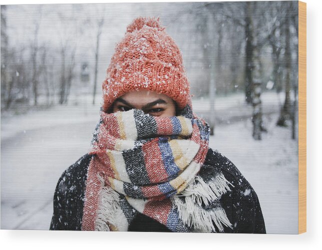 Tranquility Wood Print featuring the photograph A young woman enjoying snowfall in Amsterdam by Paulo Amorim