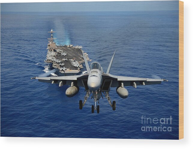 F A 18e Wood Print featuring the photograph An FA-18 Hornet demonstrates air power. by Paul Fearn