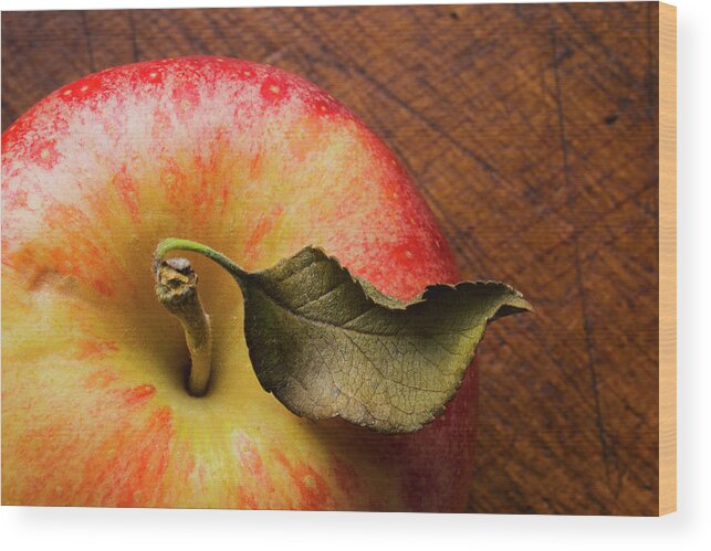 Wood Wood Print featuring the photograph Apple On Wooden Table by Tetra Images
