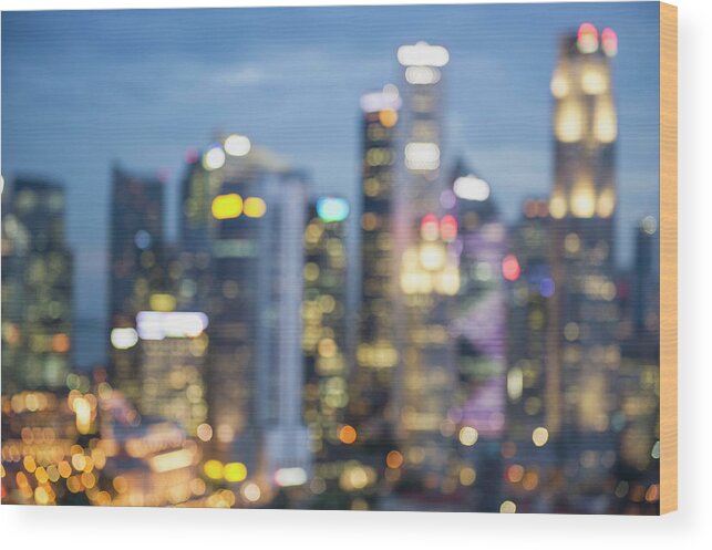 Downtown District Wood Print featuring the photograph Blurred View Of City Skyline Lit Up At by Jacobs Stock Photography Ltd