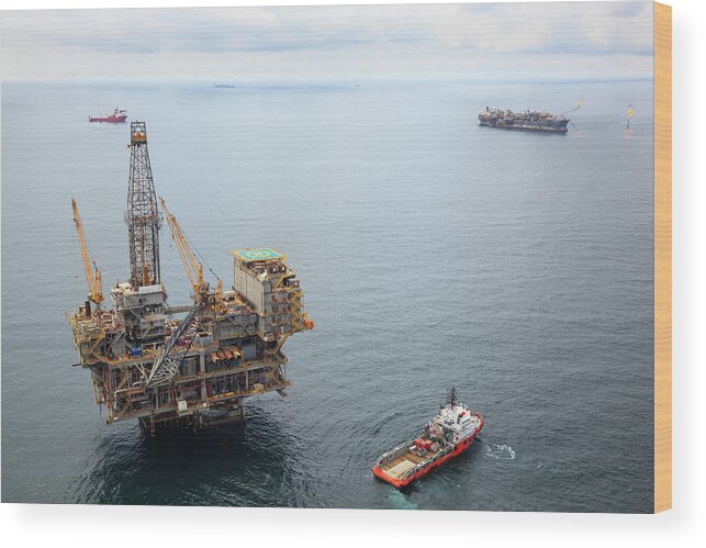 Oil Rig Supply Ship Wood Print featuring the photograph Busy Oil Field by Heliry