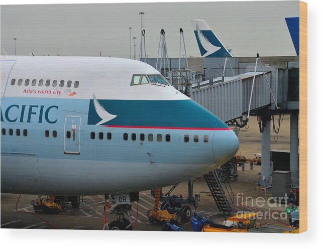 Cathay Pacific Wood Print featuring the photograph Cathay Pacific 747 jumbo jet parked at Hong Kong airport by Imran Ahmed