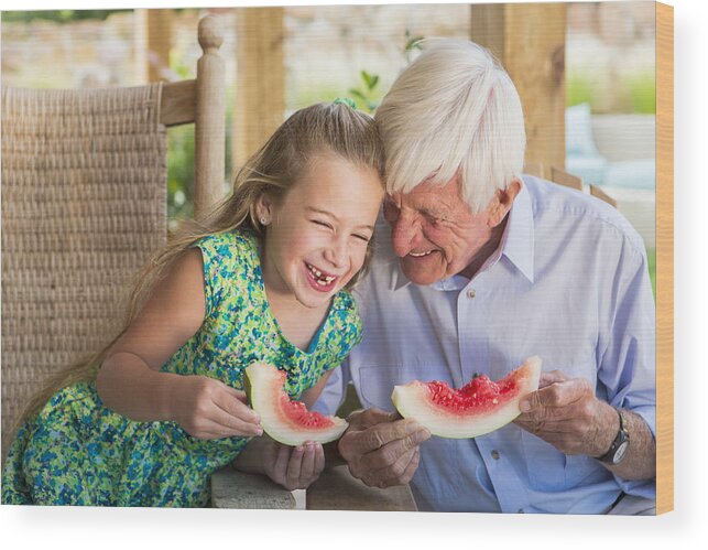 Child Wood Print featuring the photograph Caucasian man and granddaughter eating watermelon by Marc Romanelli
