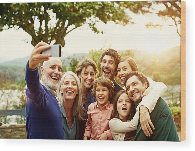Tranquility Wood Print featuring the photograph Cheerful family taking selfie by Morsa Images