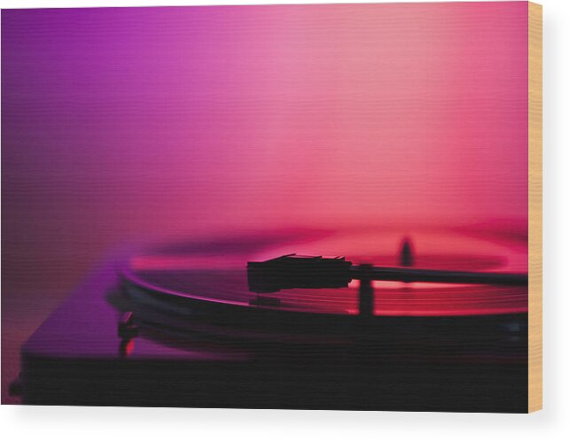 Concert Wood Print featuring the photograph Close up of turntable on pink background by Daniel Grill