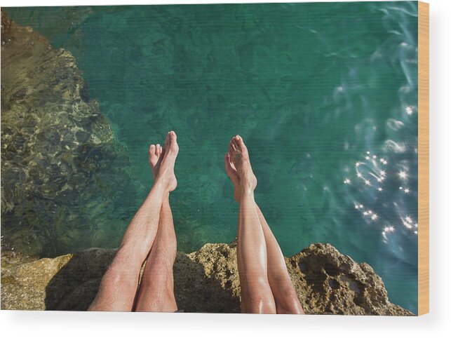 Heterosexual Couple Wood Print featuring the photograph Couples Legs Above Turquoise Ocean by Picturegarden