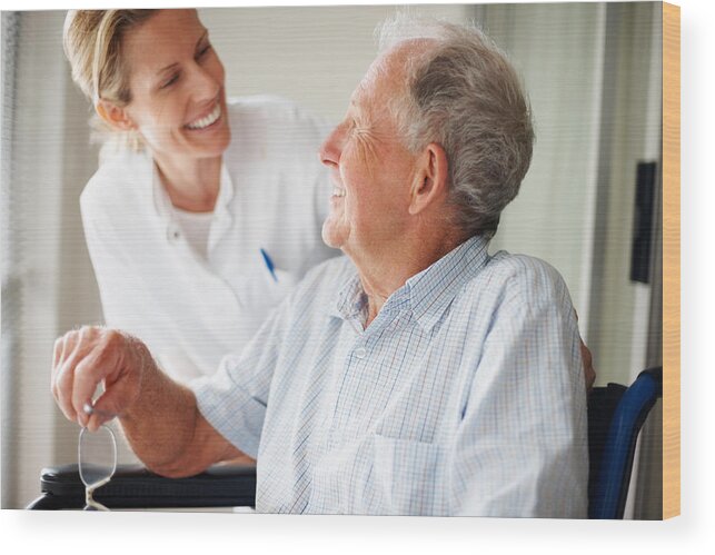 Expertise Wood Print featuring the photograph Elderly man speaking to a nurse by Jacob Wackerhausen