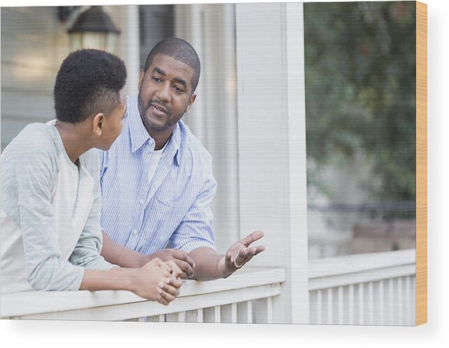 Punishment Wood Print featuring the photograph Father and son in serious front porch conversation by Asiseeit