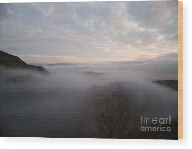 Fog Wood Print featuring the photograph Fog at sunrise in Jerome Arizona with San Francisco Peaks of Flagstaff in the distance by Ron Chilston