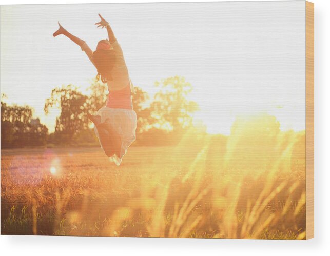 Human Arm Wood Print featuring the photograph Girl jumping into the sunshine by Olivia Bell Photography