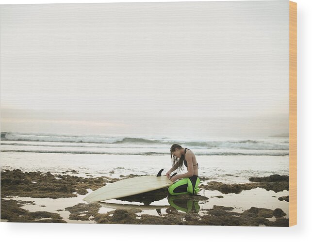 Three Quarter Length Wood Print featuring the photograph Girl Preparing Surfing Board On Rocky by Stanislaw Pytel