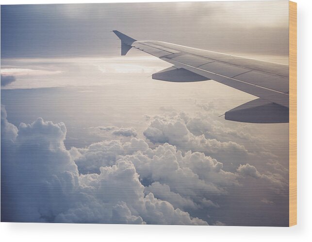 Tranquility Wood Print featuring the photograph Image of airplane wing flying above the clouds by Moazzam Ali Brohi