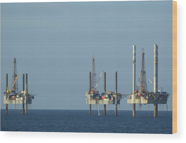 Oil Rig Wood Print featuring the photograph Jack up well platforms by Bradford Martin
