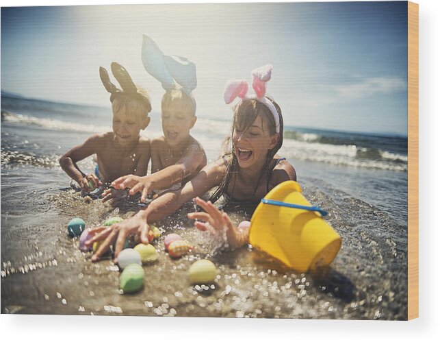 Easter Bunny Wood Print featuring the photograph Kids playing in sea during summer Easter by Imgorthand