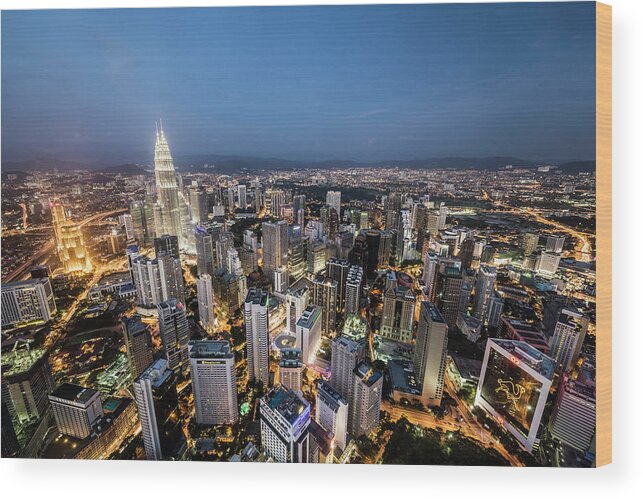 Built Structure Wood Print featuring the photograph Kuala Lumpur Skyline At Dusk,elevated by Martin Puddy