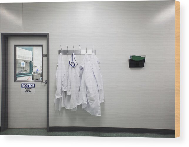 Medical Research Wood Print featuring the photograph Lab coats on hanger by Cavan Images