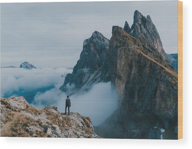 Tranquility Wood Print featuring the photograph Man hiking near Seceda mountain in Dolomites by Oleh_Slobodeniuk