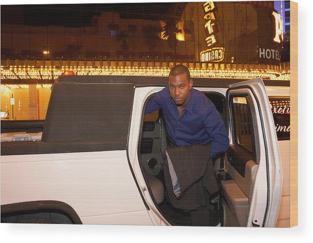 Young Men Wood Print featuring the photograph Man leaving limousine in front of casino, portrait by Erik Snyder