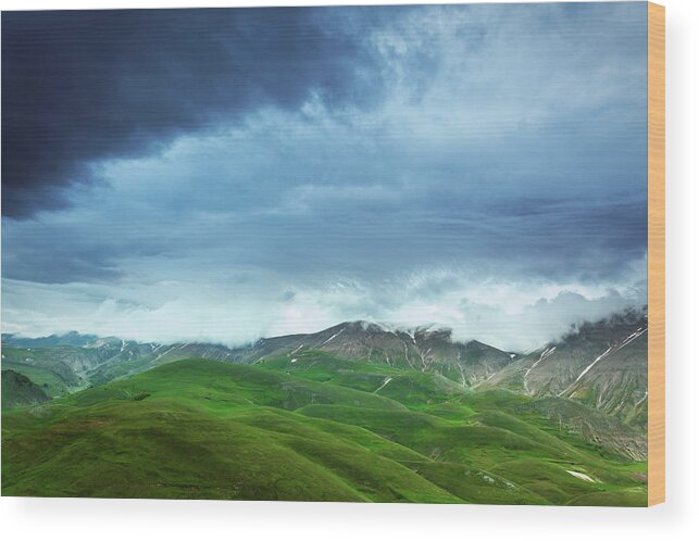 Scenics Wood Print featuring the photograph Mountains Under Heavy Clouds by Mammuth