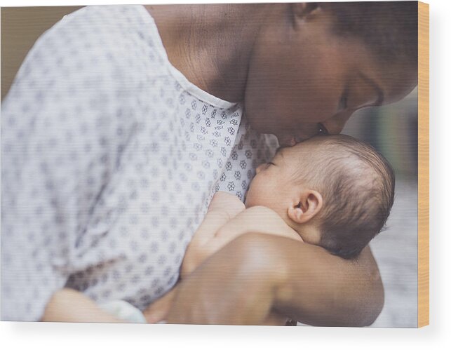 People Wood Print featuring the photograph New Mom Holds Her Infant to Her Chest by FatCamera