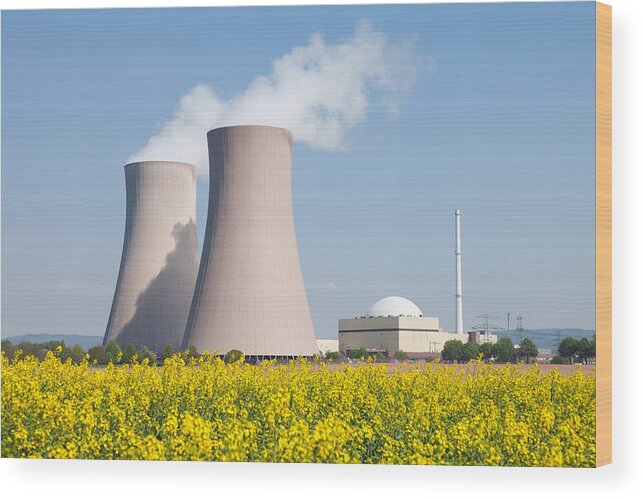Scenics Wood Print featuring the photograph Nuclear power station with steaming cooling towers and canola field by RelaxFoto.de