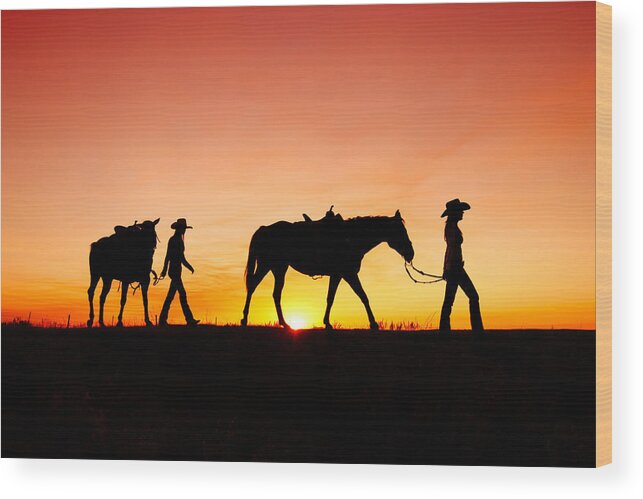 Cowgirls Silhouette Horses Sunset Sunrise Twilight Horizon Landscape Beautiful Sexy Sky Women Two Pair Girls Cowboys Rural Ranch Countryside Havre Montana Country Evening Saddle Outdoors Beauty Nature Sun Sunlight Orange American West Side View Yellow Dusk Dawn Leading Harness Halter Walking Agriculture Guest Ranch Recreation Femininity Young Feminine Legs Bright Back Lit Horizon Over Land Western West Great Plains Equine Quarter Horse Best Wood Print featuring the photograph Off to the Barn by Todd Klassy