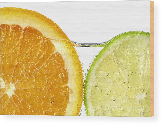 Orange Wood Print featuring the photograph Orange and lime slices in water by Elena Elisseeva