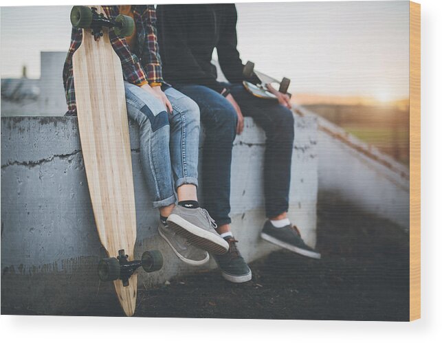 Adolescence Wood Print featuring the photograph Skateboarders taking a rest in skate park by Hobo_018